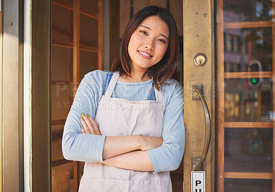 Buy stock photo Portrait, waitress and Asian woman with arms crossed at door of restaurant, coffee shop or store. Face, smile and confident barista, happy employee or small business entrepreneur at cafe in Japan