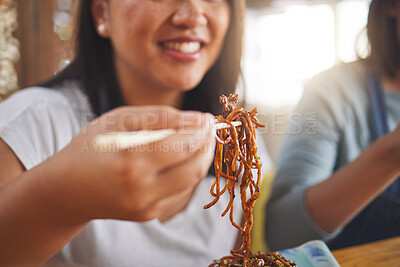 Buy stock photo Asian, noodles and woman at a restaurant eating for dinner or lunch meal using chopsticks and happy for ramen nutrition. Plate, young and person enjoy Japanese cuisine, food or diet at a table