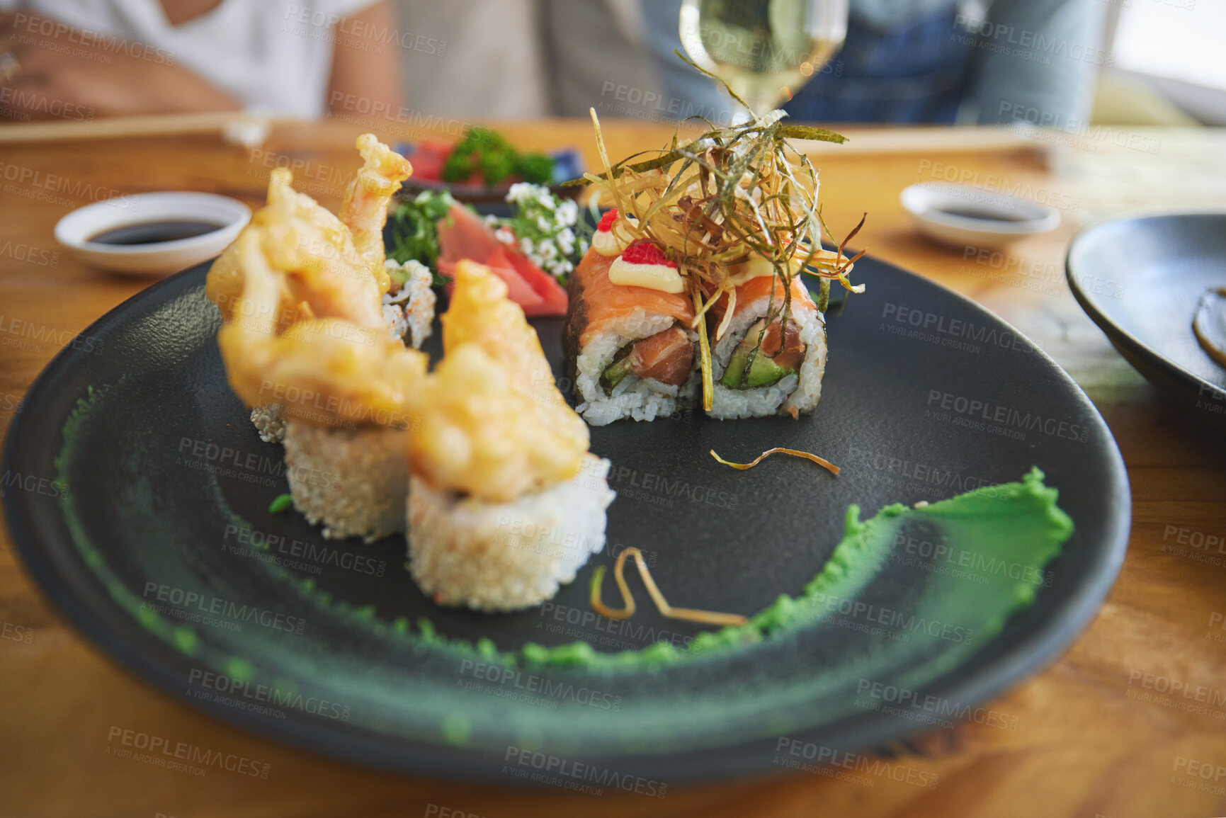 Buy stock photo Japanese, sushi and food at a restaurant for dinner or lunch meal at a healthy Asian cafe on table. Plate, cuisine and fine dining takeaway or seafood from a Salmon menu for diet or nutrition