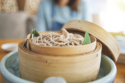 Buy stock photo Restaurant, steamer and closeup of a bowl of noodles for healthy Asian cuisine for diet. Food, bamboo pot and zoom of Japanese ramen for a nutrition meal for dinner, lunch or supper at a diner.