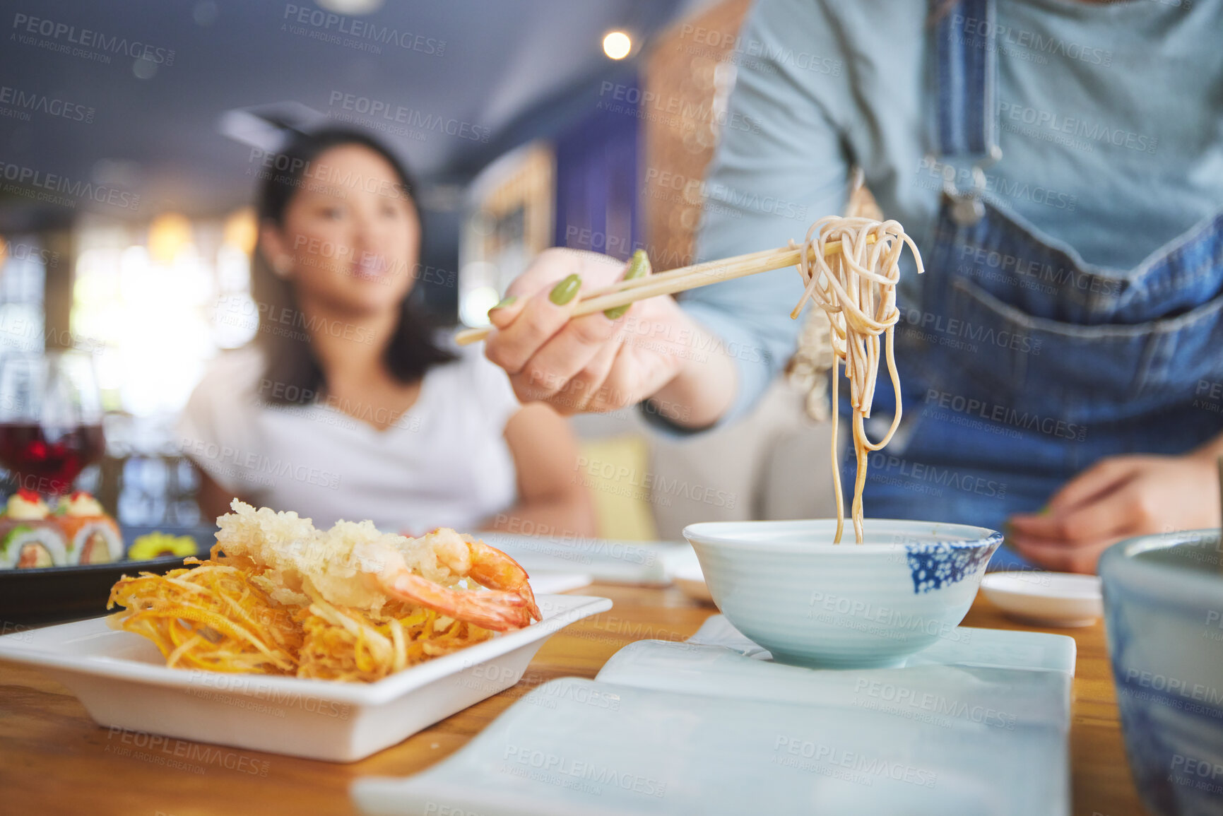 Buy stock photo Hand, ramen and chopsticks for Chinese food with a woman closeup in a restaurant to eat a meal. Soup, noodles and cuisine with a customer in an eatery for nutrition or traditional Japanese dinner