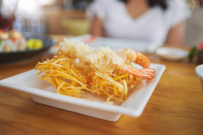 Buy stock photo Food, sushi and cuisine on a table in a restaurant for a traditional asian dish or meal closeup. Seafood, fine dining and shrimp tempura on a plate in a chinese eatery for hunger or nutrition