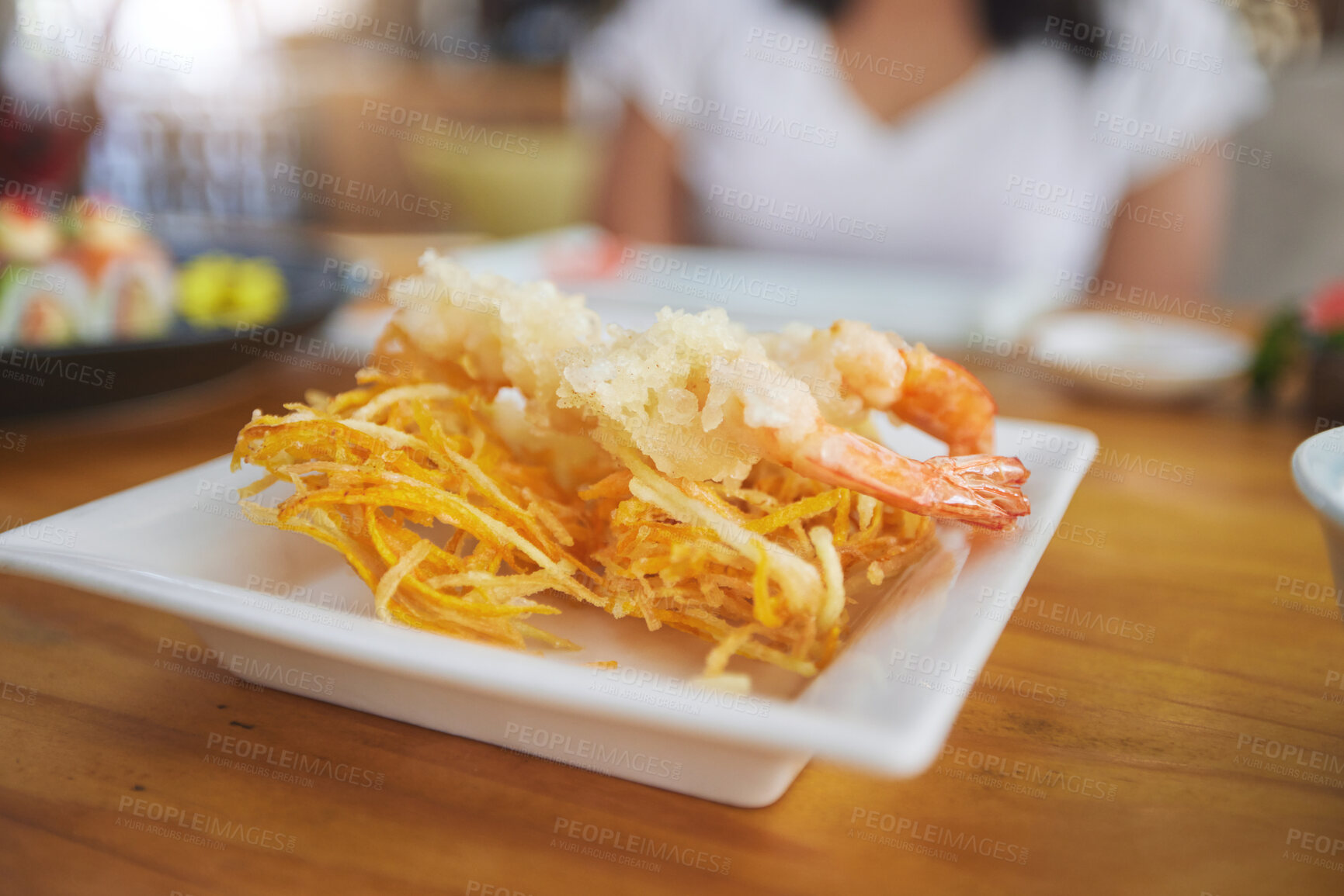 Buy stock photo Food, sushi and cuisine on a table in a restaurant for a traditional asian dish or meal closeup. Seafood, fine dining and shrimp tempura on a plate in a chinese eatery for hunger or nutrition