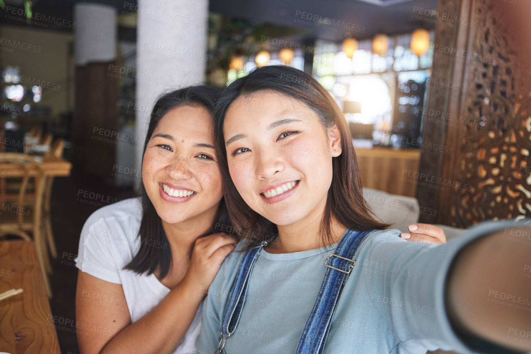 Buy stock photo Selfie, love and an LGBT couple in a restaurant for a romantic date together on their anniversary. Portrait, smile and a happy asian woman with her lesbian partner in a cafe for a celebration