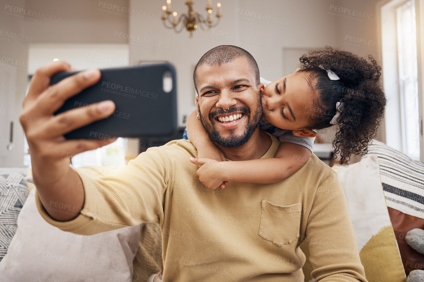 Buy stock photo Father, girl and selfie kiss in home living room, bonding and having fun together. Dad, child and hug in profile picture, happy memory and smile on social media post of family on sofa, love and care