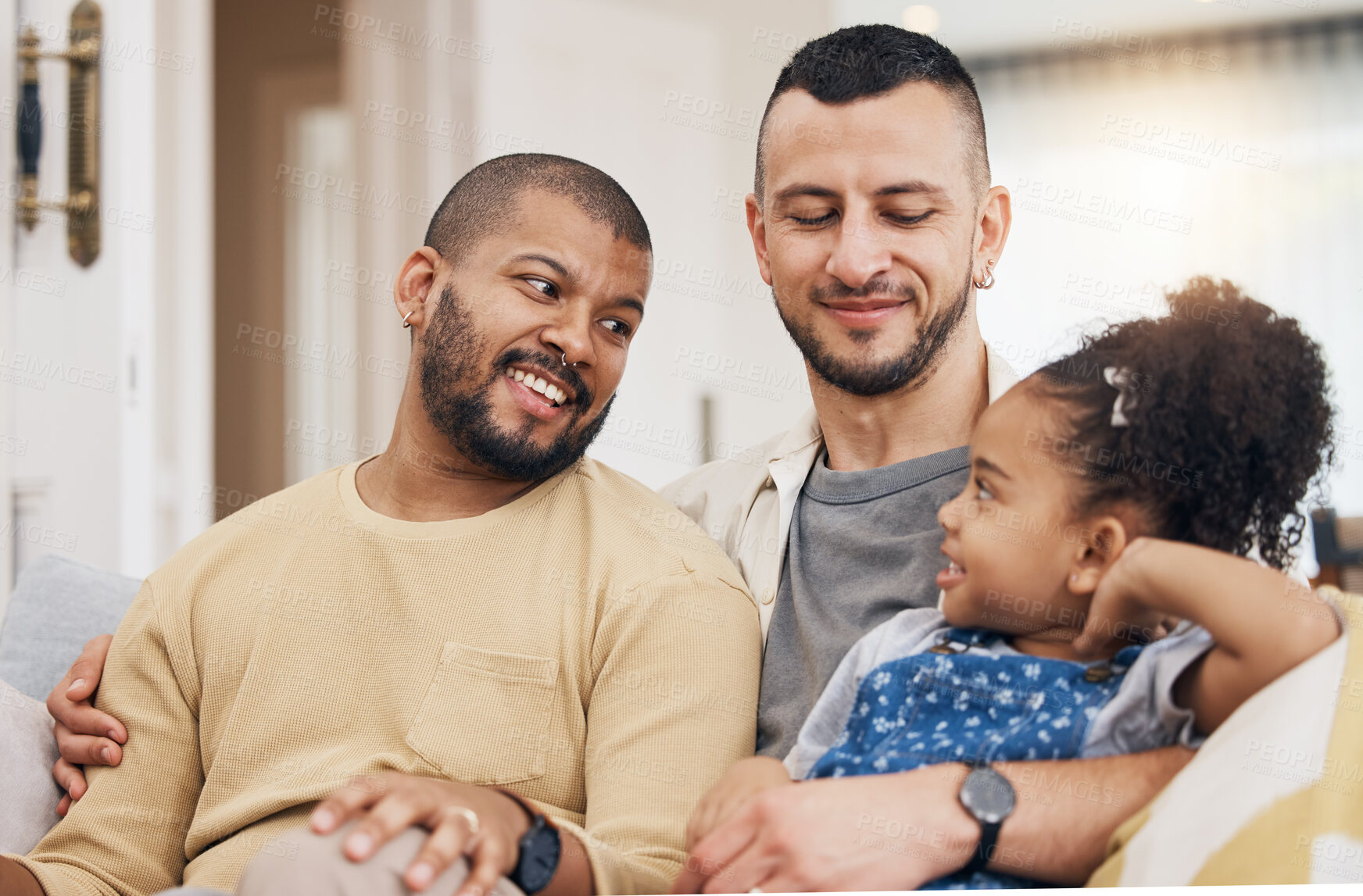 Buy stock photo Child, gay family and happy on a sofa at home with love, care and safety in a lounge. Lgbtq men, interracial and adoption with foster girl kid together on a couch for happiness, bonding and to relax