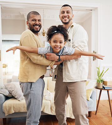 Buy stock photo Gay parents, girl and portrait of playing in home or holding kid as a plane, lifting or flying in living room for fun bonding game. Happy family, father and dad support child in the air or lounge