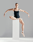 Balance, ballerina or woman on block in studio in creative portrait or elegant performance for art or freedom. Girl, dancer or ballet dancing or training to exercise on platform or white background