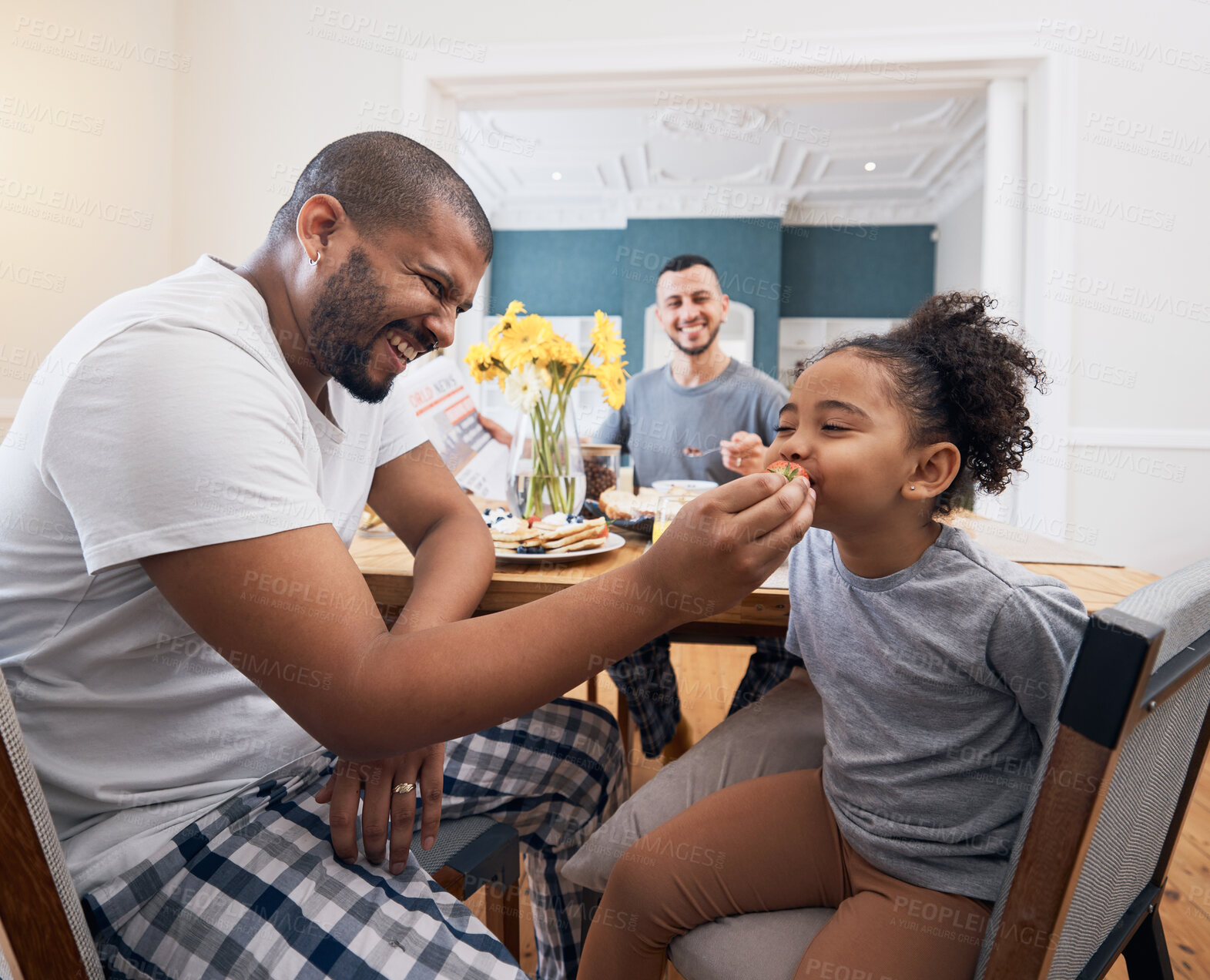 Buy stock photo Gay couple, breakfast and dad feeding kid meal, food or cereal for morning wellness, care and youth development support. Family, adoption and non binary father smile for hungry child eating at home