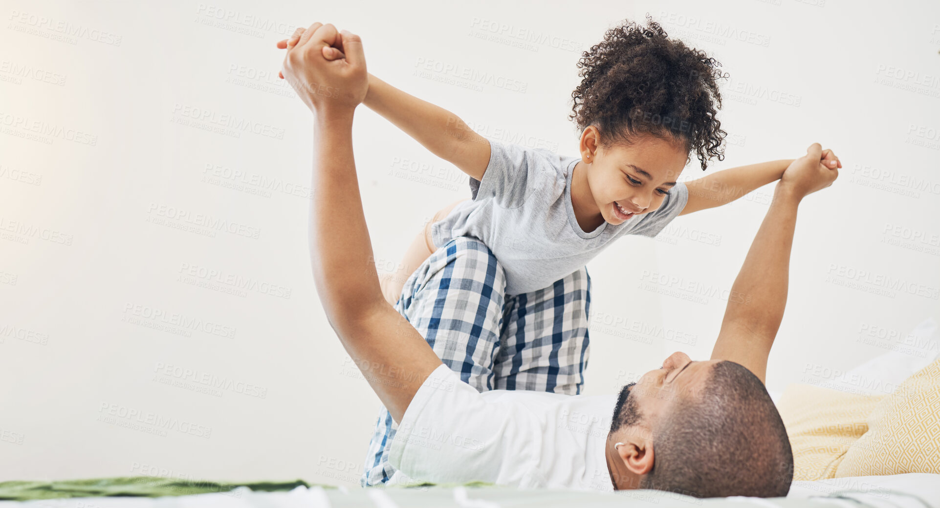 Buy stock photo Home, father and daughter on a bed for airplane game, bonding and happiness in morning. Excited girl child and man or parent together in a family bedroom for fun, playing and support for lift in air