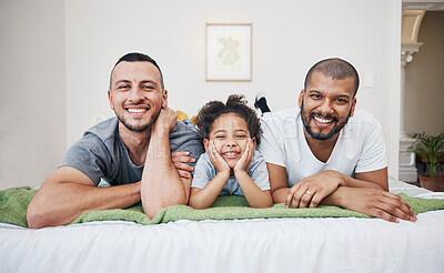 Buy stock photo Gay, happy family and a child on a bed at home with love, care and safety in a bedroom. Lgbtq men, adoption and interracial parents with foster girl kid together in morning with a smile and happiness