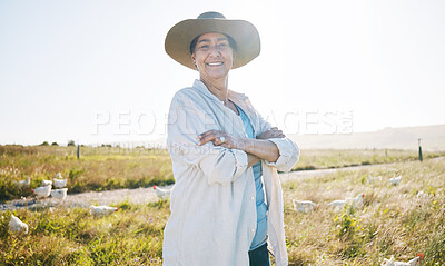 Buy stock photo Farmer, mature woman and agriculture, arms crossed on field and sustainability, land and livestock. Chicken farm, agro business and confidence, countryside and environment with nature and portrait