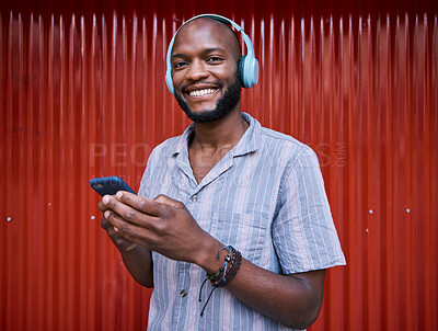 Buy stock photo Black man, phone and headphones, smile with technology and media for podcast, music and online streaming. Happy, person and smartphone with radio app for listening to audio, sound and multimedia 
