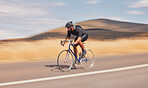 Speed, nature and road, man on bicycle for workout, exercise and scenic mountain path. Health, wellness and cyclist on bike for morning training, practice and cycling race, blue sky and fast motion.