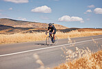 Fitness, nature and man cycling on road for workout, exercise and scenic mountain path. Health, wellness and cyclist on bike on summer morning for training, practice and bicycle race with blue sky.