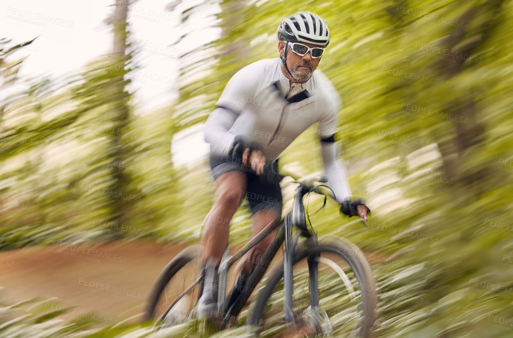 Buy stock photo Blurred nature, cycling and man athlete training for a race, marathon or competition in a forest. Fast, fitness and male cyclist riding bicycle at speed for cardio exercise or workout on a mountain.