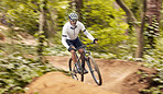 Nature cycling, bicycle and sports man travel, ride and journey on off road path, outdoor challenge or bike exercise. Fast bike, speed blue and athlete training, fitness and workout in forest