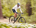 Nature, bicycle or fast sports man travel, ride and journey on off road adventure, outdoor challenge or bike exercise. Cycling action, speed blur or athlete training, fitness and competition in woods
