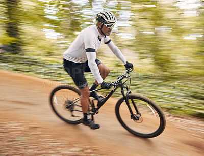 Buy stock photo Blurred speed, cycling and man in nature training for a race, marathon or competition in a forest. Fast, fitness and male cyclist athlete riding bicycle for cardio exercise or workout on a mountain.