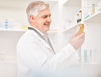 Buy stock photo Medical, product and a senior man in a pharmacy looking for prescription medicine on a shelf. Bottle, healthcare or trust with a happy pharmacist in a drugstore for chronic medication inventory