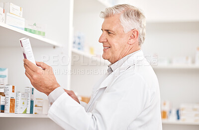 Buy stock photo Healthcare, product and a senior man in a pharmacy looking for prescription medicine on a shelf. Box, medical or trust with a happy pharmacist in a drugstore for chronic medication inventory or stock