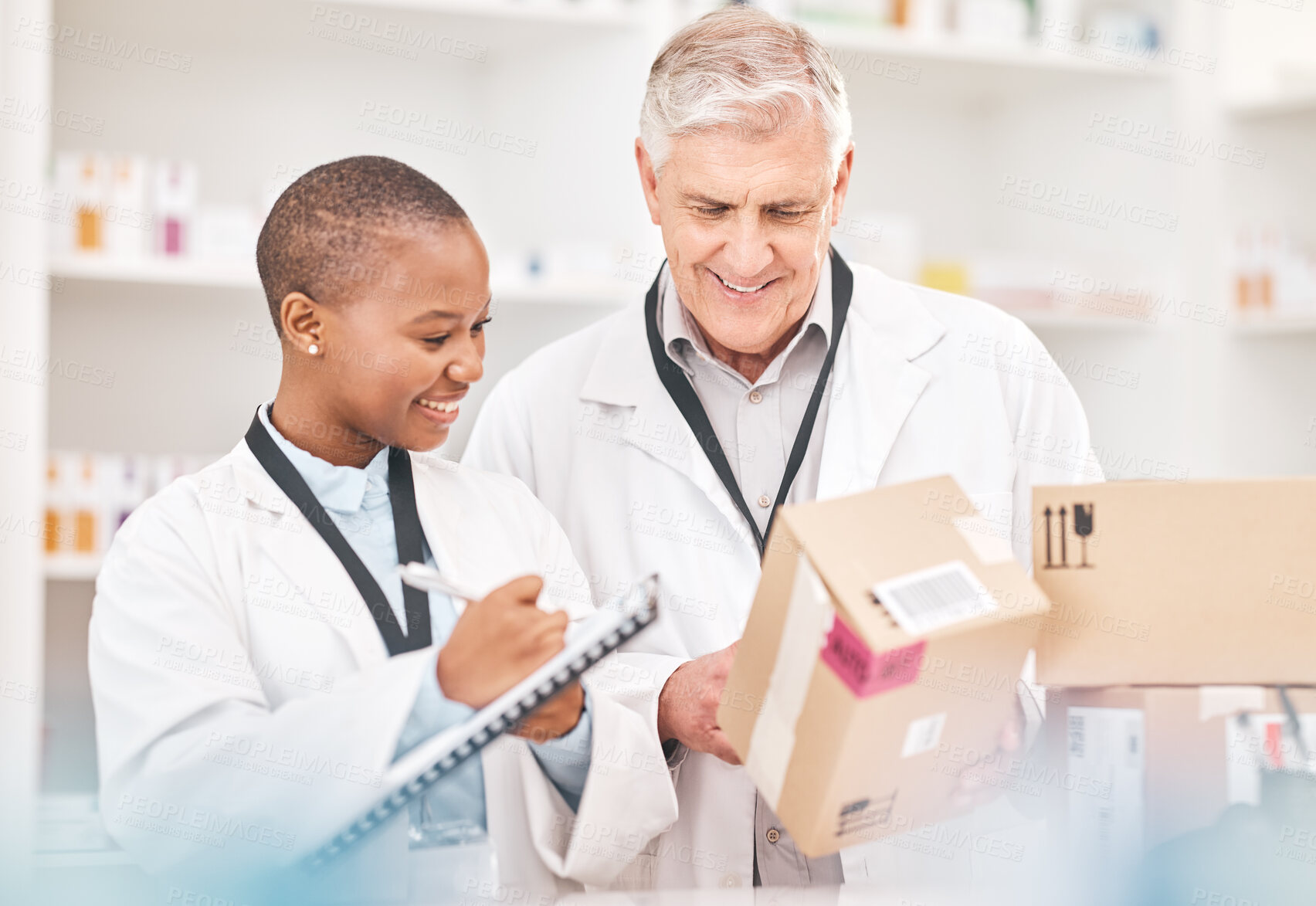 Buy stock photo Man, woman and boxes in pharmacy for checklist, delivery schedule or stock report for medicine. Help, mentor and pharmacist team with inventory list, pharmaceutical product package with medical info.