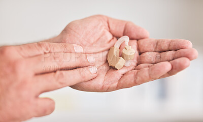 Buy stock photo Hearing aid, hands and person with disability for listening, healthcare support or medical innovation. Closeup of deaf patient with audiology implant for sound waves, amplifier or help improve volume