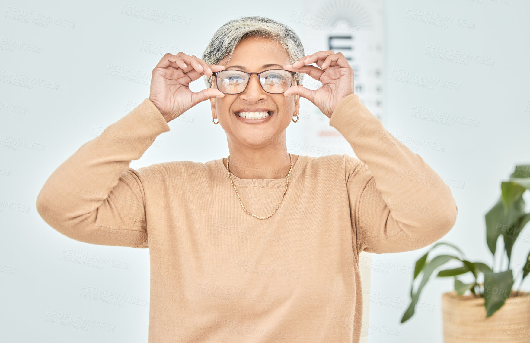 Buy stock photo Mature woman, portrait and glasses for vision eye, test and optometry in clinic wellness, choice and prescription frames. Person, smile and Mexican patient in store, shop and eyesight retail decision