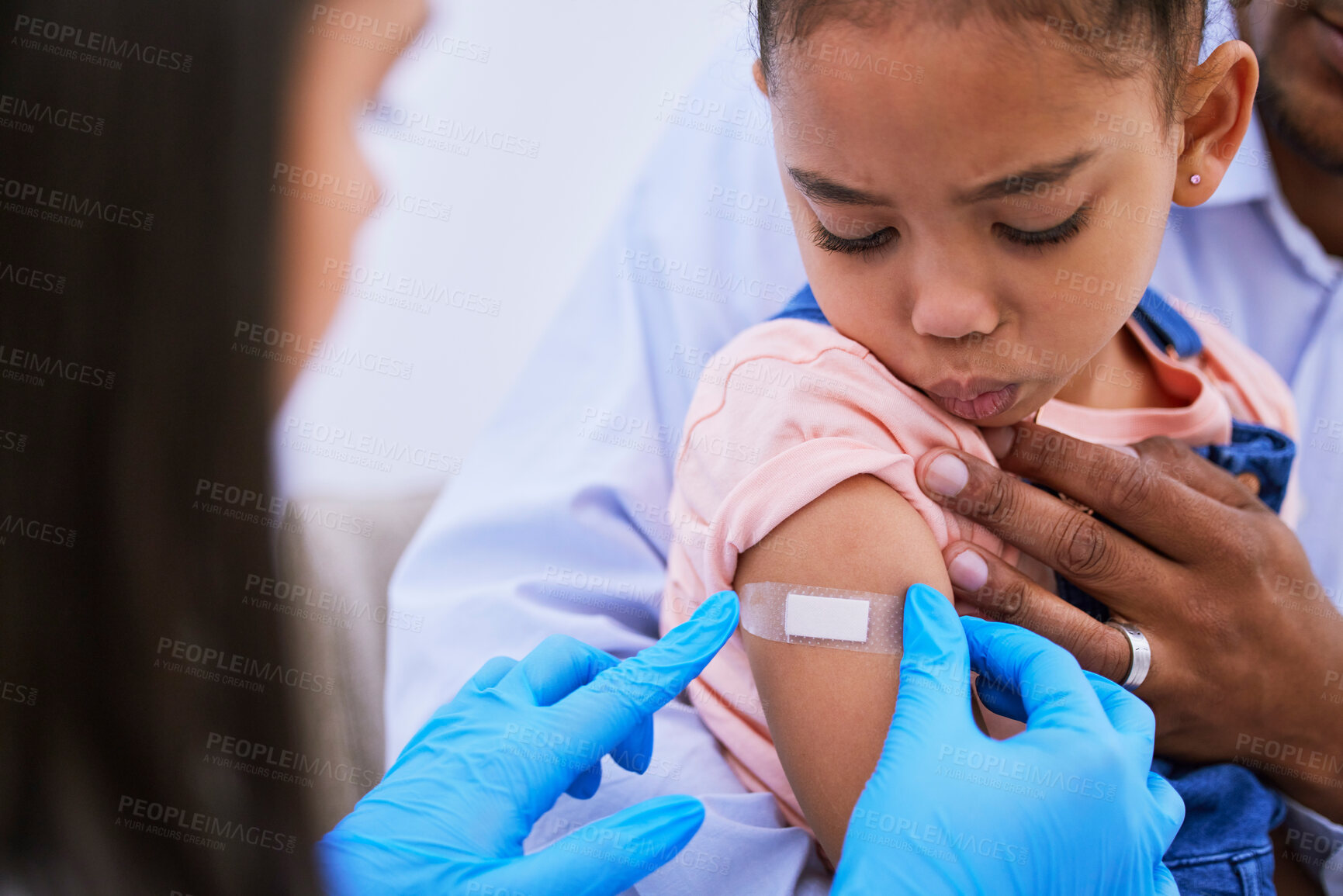 Buy stock photo Doctor, dad and kid with plaster for vaccine, flu shot or medicine injection in clinic or hospital. Father, girl with bandage and pediatrician in office for vaccination, consultation and child care.