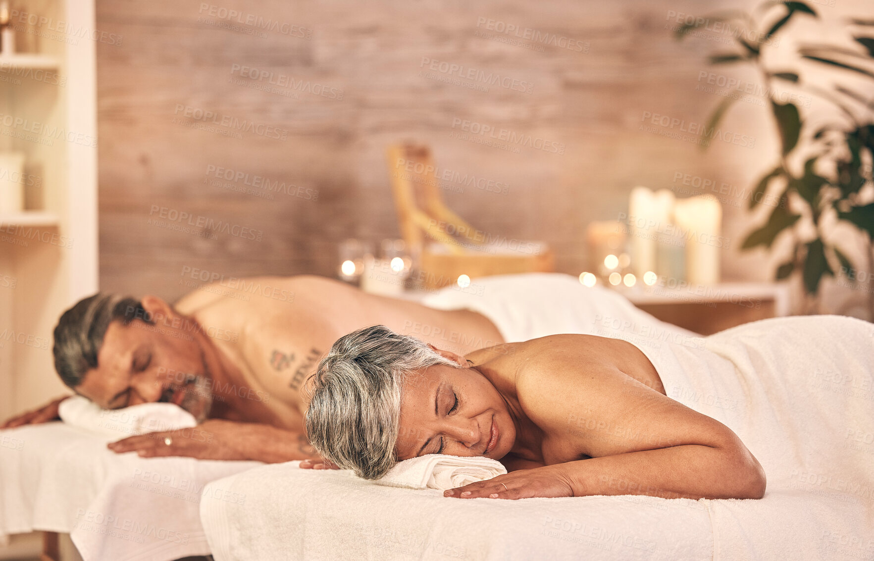 Buy stock photo Wellness, massage and couple in spa to relax on holiday, vacation and anniversary celebration. Love, luxury resort and mature man and woman on bed in salon for beauty, therapy and skincare treatment