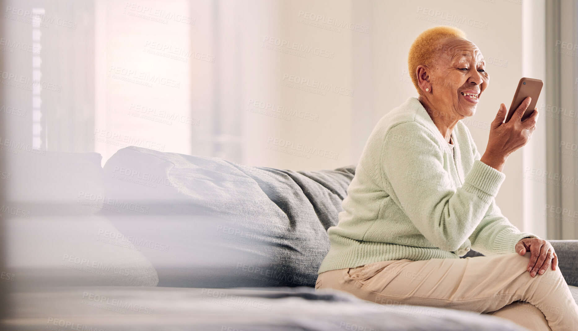 Buy stock photo Video call, senior woman audio and living room with conversation and communication in a home. Retirement, African elderly female person and mobile discussion on a sofa with contact and mockup space