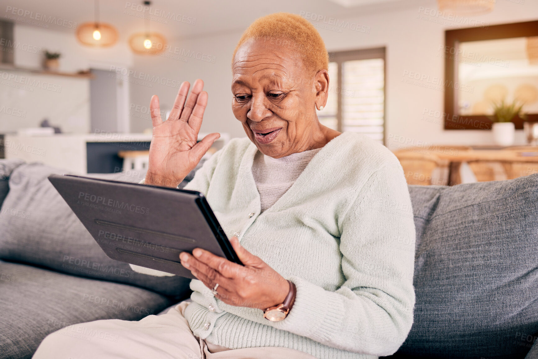 Buy stock photo Senior, woman and hello on virtual tablet in home on sofa for social, communication and video call. Happy, love and old person talk on digital phone for networking and connection in living room