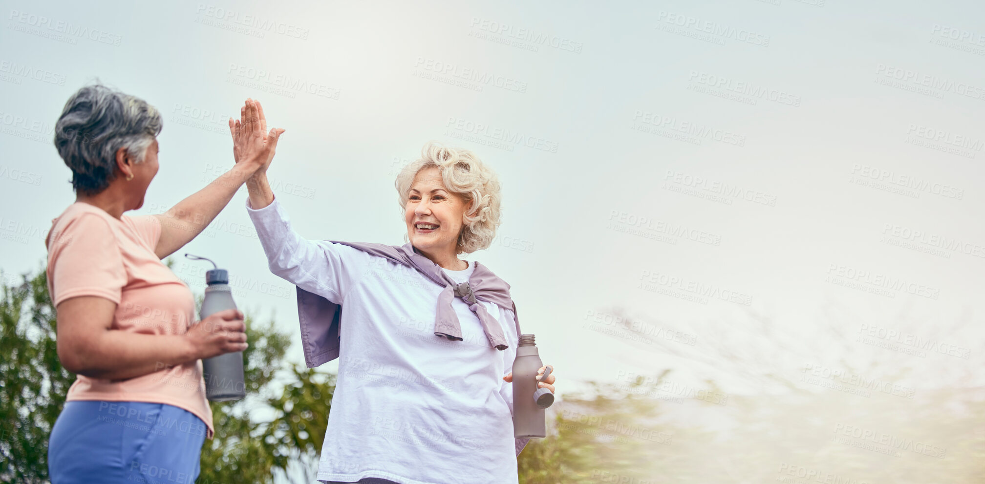 Buy stock photo Senior women, walking and high five for motivation and workout success from outdoor fitness. Banner, elderly friends and happy from sport and exercise together with support smile and mockup space