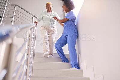 Buy stock photo Steps, nurse and help elderly woman, holding hands and assistance in home. Caregiver, stairs and senior African patient walking down, support of person with a disability and kindness in healthcare