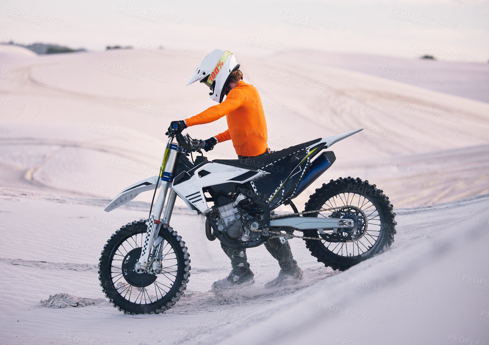 Buy stock photo Bike, sand and freedom with a sports man pushing a vehicle in the desert for adventure or adrenaline. Motorcycle, training and dunes with an athlete outdoor in nature for power or active competition