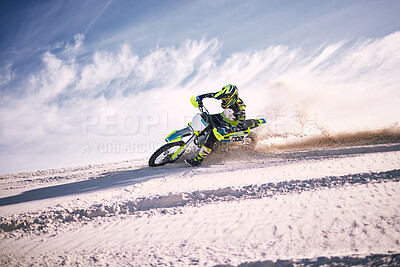 Buy stock photo Bike, sky and speed with a man on sand riding a vehicle in the desert for adventure or adrenaline. Motorcycle, training and dust with an athlete outdoor in nature for freedom, power or competition