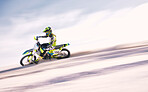 Bike, mockup and motion blur with a man on sand riding a vehicle in the desert for adventure or adrenaline. Motorcycle, freedom and training on space with an athlete on space in nature for power