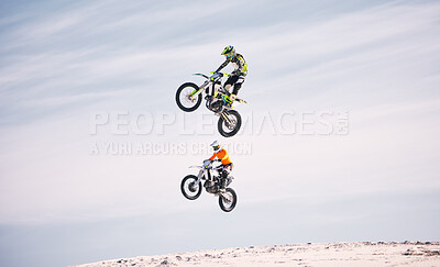 Sports, jump and people on motorcycle driving on sand, beach or training for a challenge, competition or desert rally. Dirt, motorbike and men in fearless extreme sports, stunt or jumping in the air