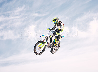 Blue sky, jump and man on motorbike in air for practice, training and extreme sports energy. Professional dirt biking speed challenge, off road adventure and danger at off road motorcycle competition