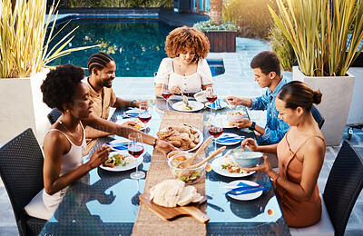 Buy stock photo Group of friends at lunch, party in garden and happy event with diversity, food and wine for bonding together. Outdoor dinner, men and women at table, people eating with drinks in backyard in summer.