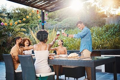 Toast, friends at dinner in garden at party and celebration with diversity, food and wine at outdoor party. Glass cheers, men and women at table, fun people with sunset drinks in backyard together.
