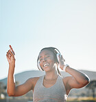 Headphones, dancing and black woman at fitness training or outdoor workout for health wellness and enjoy music. Smile, African and athlete or person streaming audio or radio for exercise in a park