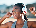 Black woman, smile and headphones, music and fitness outdoor with running, race and athlete, wellness and sport. Happy runner, audio streaming and exercise with workout, health and training for race