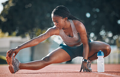 Buy stock photo Exercise, sports and a woman stretching outdoor on a track for running, training or workout. African athlete person at stadium for legs stretch, fitness and muscle warm up or body wellness on ground