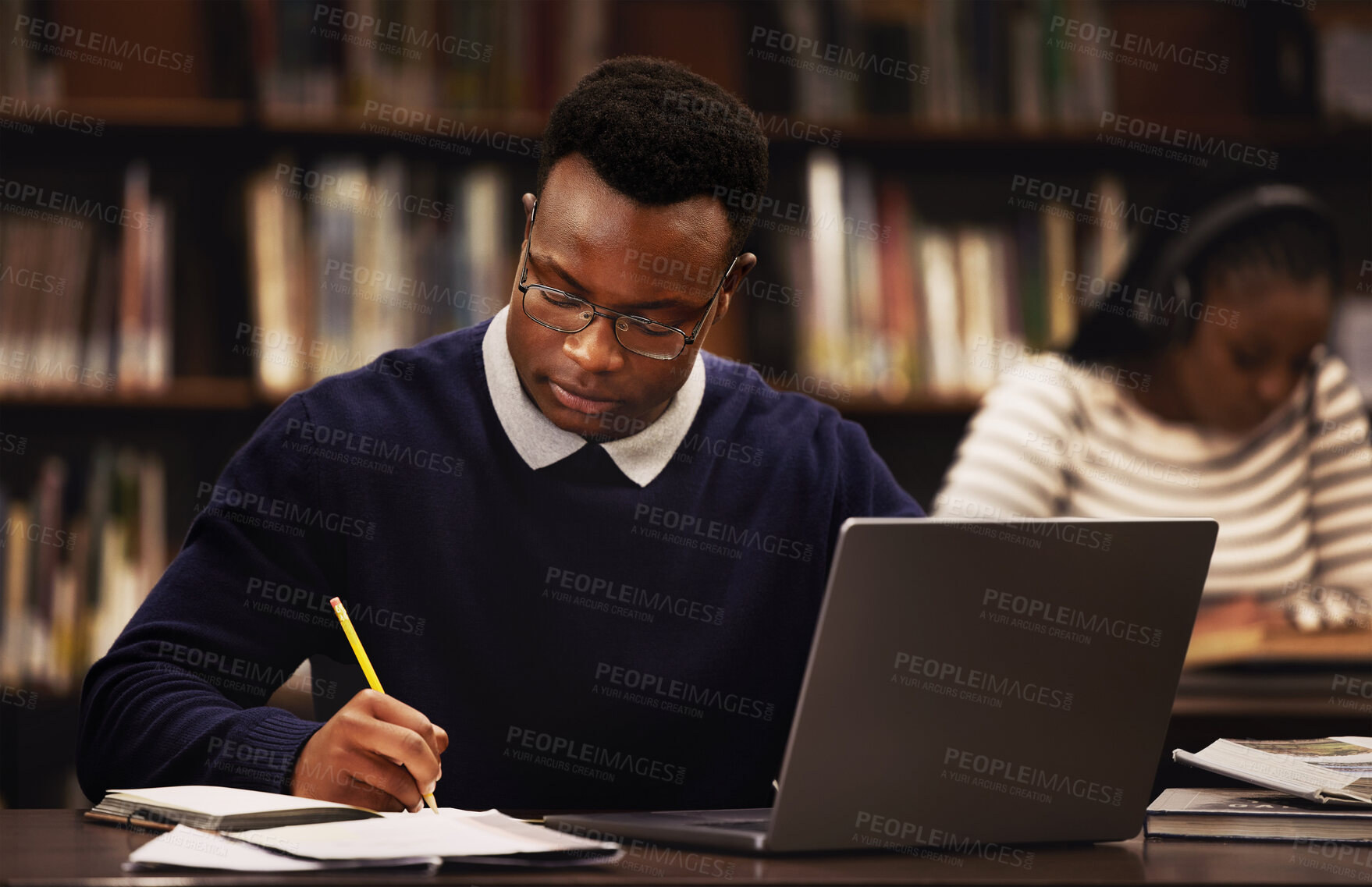 Buy stock photo Student, man and writing in library for studying, research and planning in university, scholarship and education. African person with online test and computer for language, e learning or philosophy