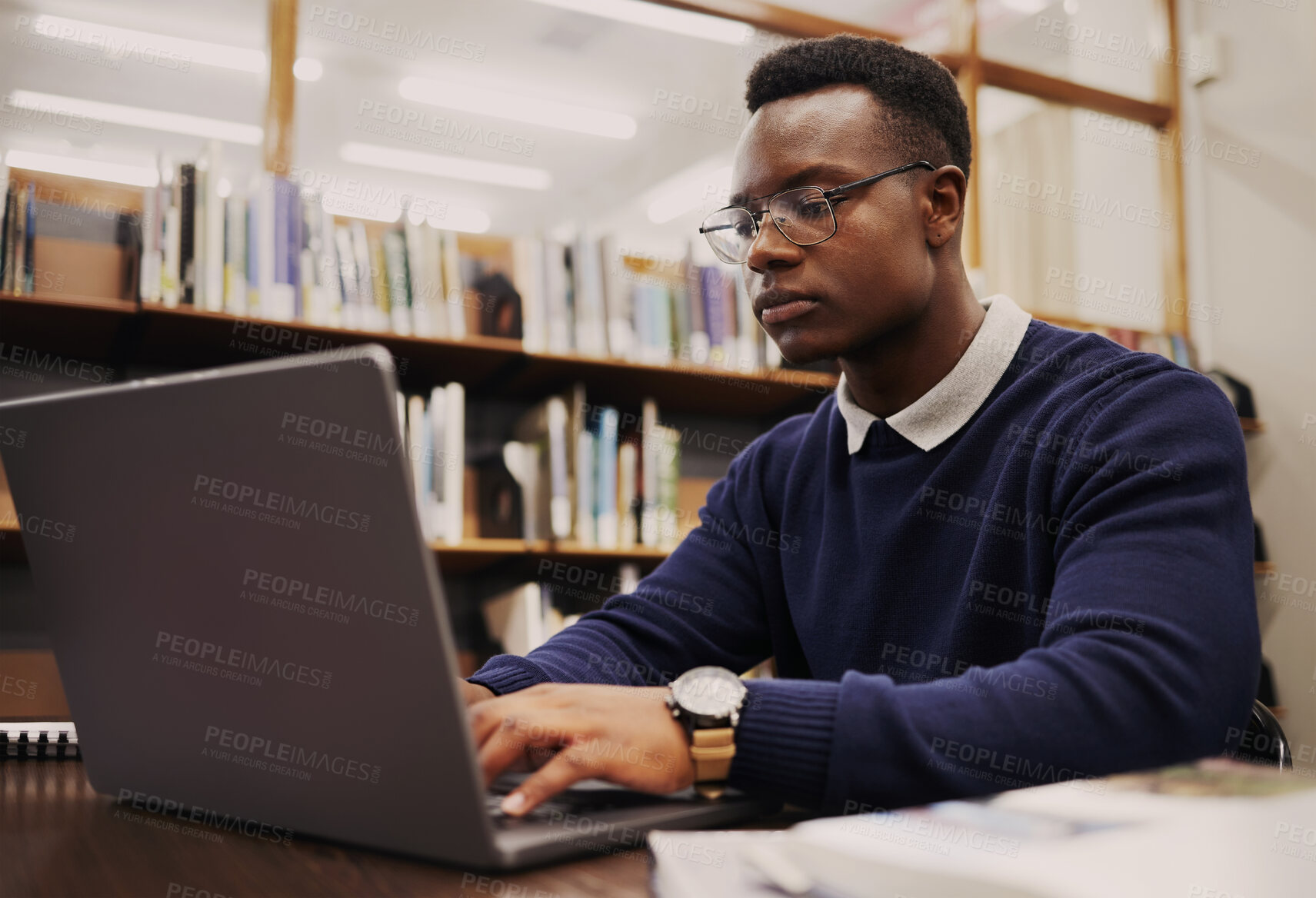 Buy stock photo Student, library and black man typing on a laptop in university or college campus working on assignment project. Online, studying and young person prepare for internet exam or doing research 