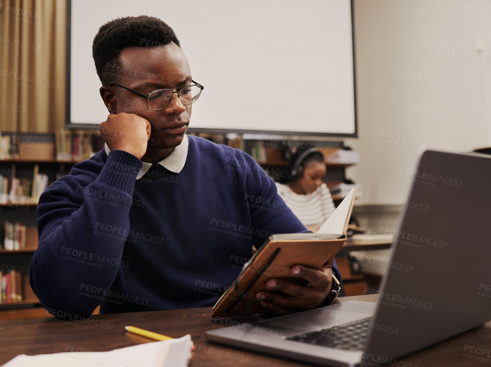 Buy stock photo University, education and black man student reading and learning in a college for knowledge development. Serious, books and person studying research to prepare for exam or assignment in a class