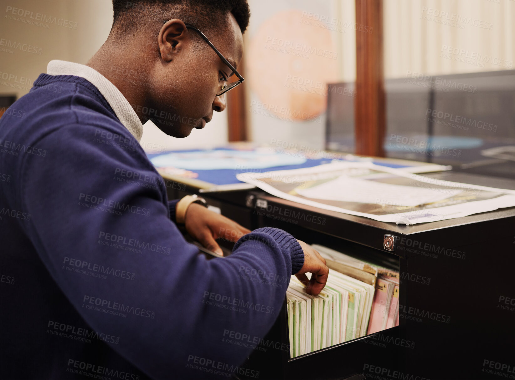 Buy stock photo School research, campus and a black man in a library for knowledge, learning or studying. University, scholarship and a young African person or student looking at books for decision or choice