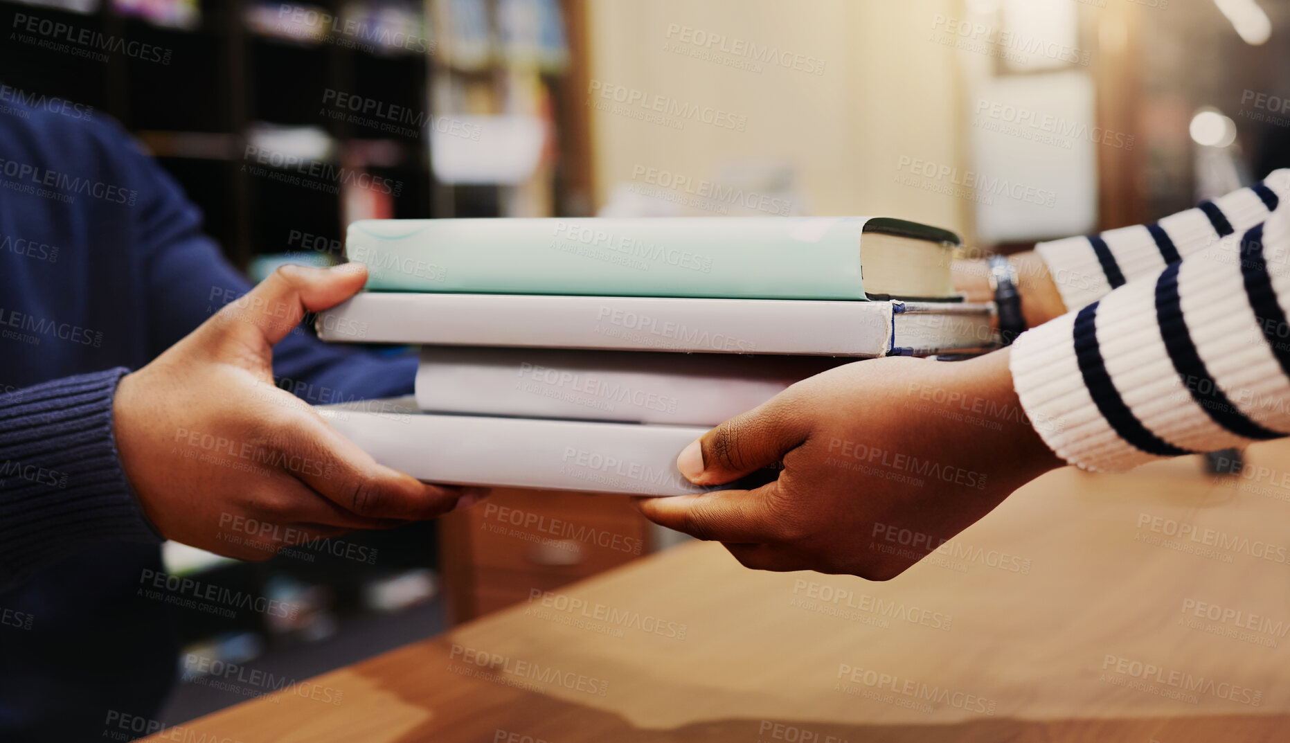 Buy stock photo Hands, library and return books for learning, knowledge or research at academy, development or reading. People, giving and closeup with welcome, care and help desk with receptionist at university