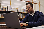 Student, frustrated and black man typing on a laptop in university or college campus angry due to assignment project. Online, studying and young person prepare for internet exam or doing research 